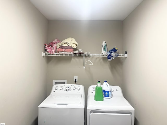 clothes washing area with laundry area and separate washer and dryer