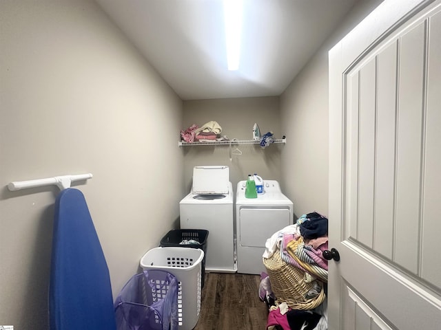 washroom with laundry area, wood finished floors, and washing machine and clothes dryer