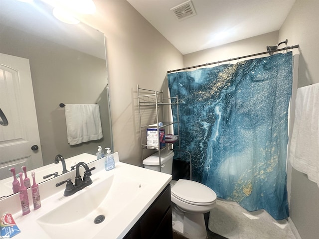 bathroom featuring vanity, toilet, a shower with curtain, and visible vents