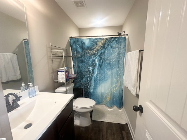 bathroom with visible vents, curtained shower, vanity, and wood finished floors