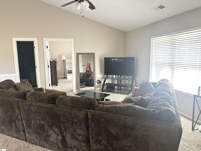 carpeted living room with vaulted ceiling, visible vents, and ceiling fan