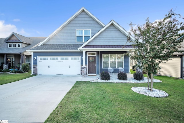 craftsman inspired home featuring a front lawn, a standing seam roof, a porch, concrete driveway, and a garage