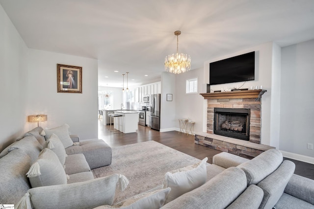 living room with dark wood finished floors, a fireplace, a wealth of natural light, and baseboards