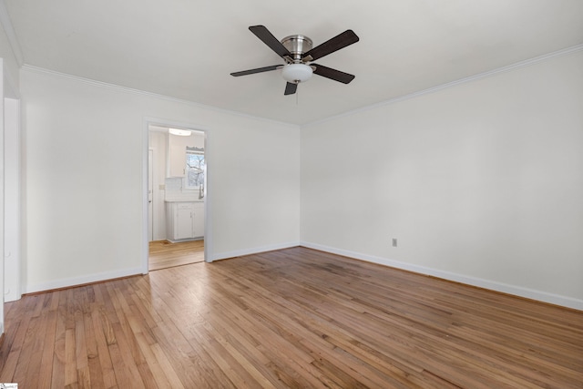 unfurnished bedroom featuring a ceiling fan, light wood-style floors, baseboards, and ornamental molding