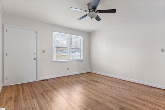 interior space featuring visible vents, baseboards, light wood-type flooring, and ornamental molding