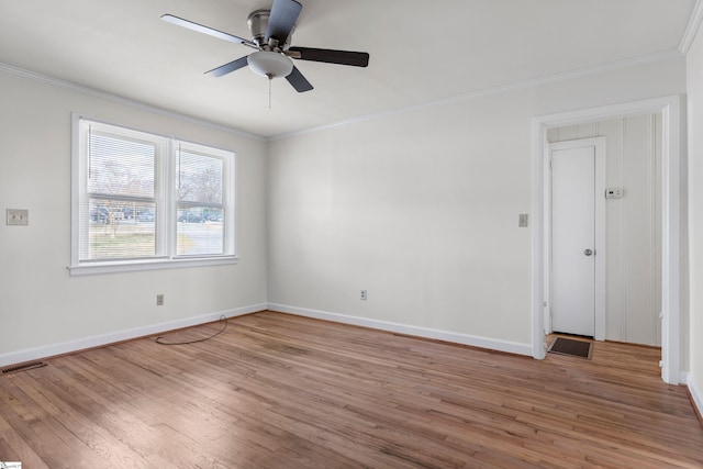 empty room with baseboards, visible vents, light wood finished floors, and ornamental molding