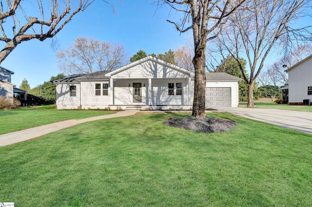 view of front facade with covered porch, an attached garage, concrete driveway, and a front lawn