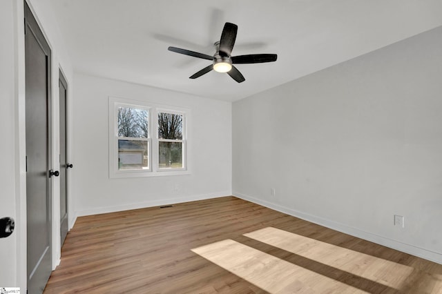 unfurnished bedroom featuring visible vents, baseboards, light wood-style floors, and ceiling fan