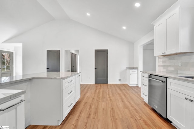 kitchen featuring lofted ceiling, white cabinetry, light wood finished floors, light stone countertops, and dishwasher