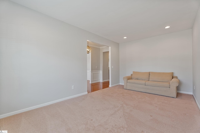 unfurnished living room featuring recessed lighting, baseboards, carpet floors, and a chandelier