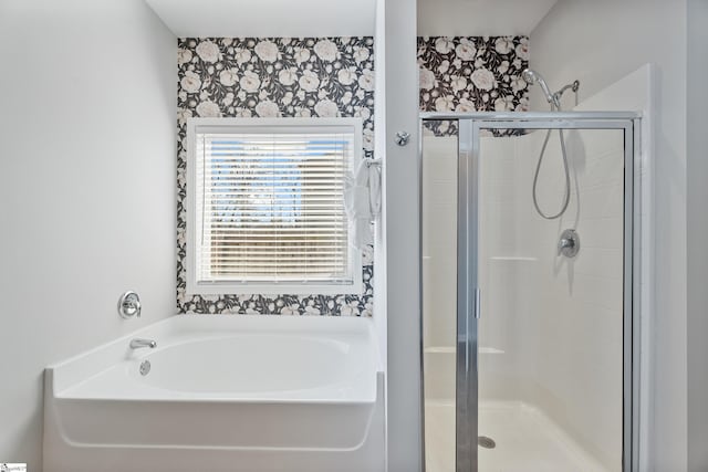 full bath featuring a bath, a shower stall, and wallpapered walls