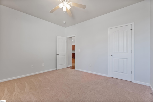 unfurnished bedroom featuring carpet flooring, a ceiling fan, and baseboards