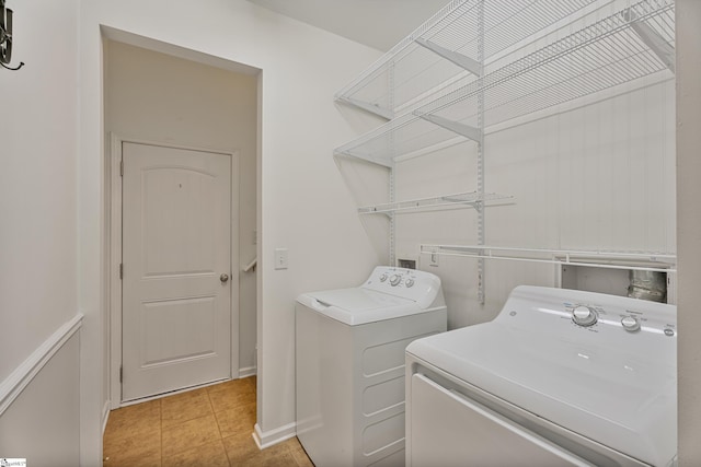 laundry area with washing machine and dryer, laundry area, and tile patterned flooring