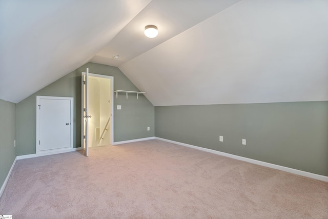 bonus room with vaulted ceiling, carpet flooring, and baseboards