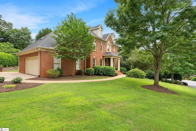 view of front of home featuring brick siding, driveway, an attached garage, and a front lawn