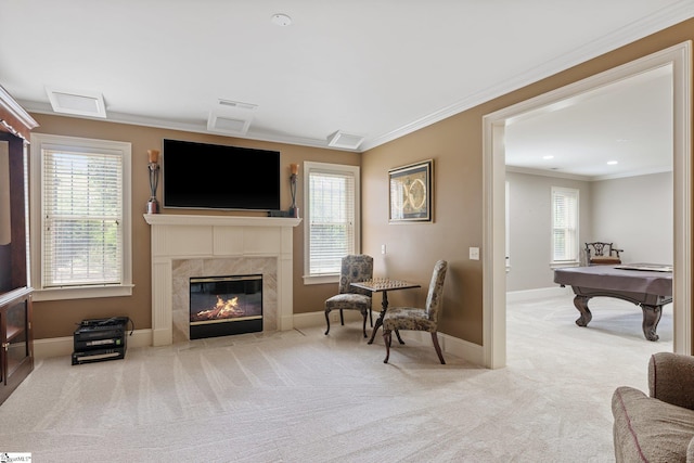 sitting room featuring plenty of natural light, carpet floors, and ornamental molding