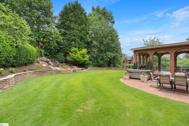 view of yard with a patio area and a hot tub