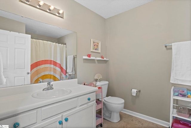 bathroom featuring vanity, a shower with shower curtain, baseboards, tile patterned floors, and toilet