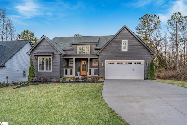 view of front facade with a porch, roof with shingles, concrete driveway, and a front lawn