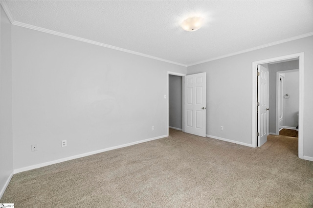 unfurnished bedroom with a textured ceiling, carpet flooring, baseboards, and ornamental molding