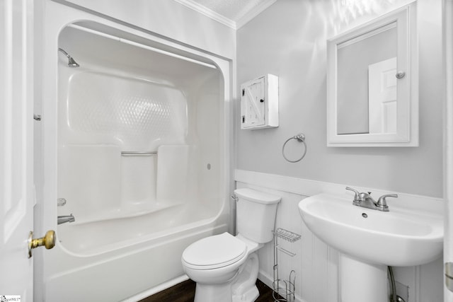 bathroom with crown molding, toilet, wainscoting, shower / bathing tub combination, and wood finished floors