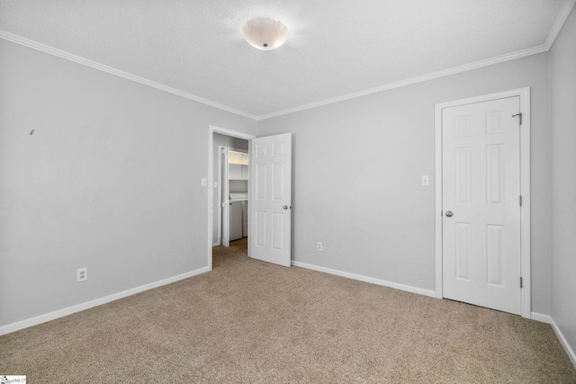 unfurnished bedroom featuring a textured ceiling, baseboards, crown molding, and carpet