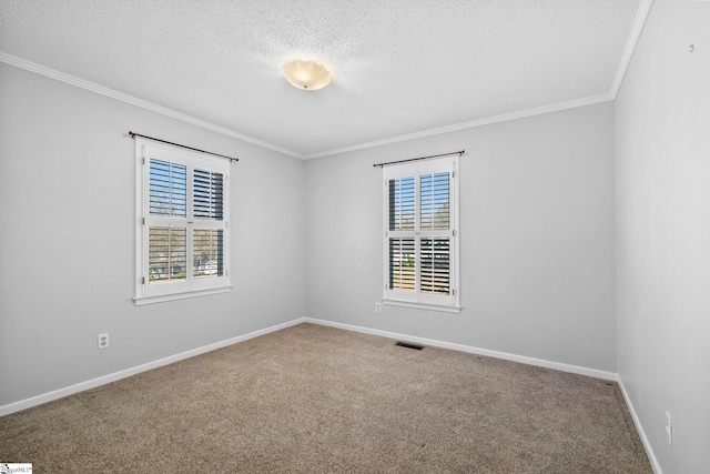 empty room with plenty of natural light, carpet, visible vents, and ornamental molding