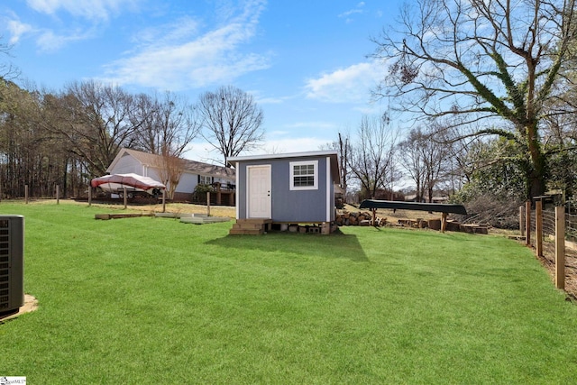 view of yard featuring an outbuilding and fence