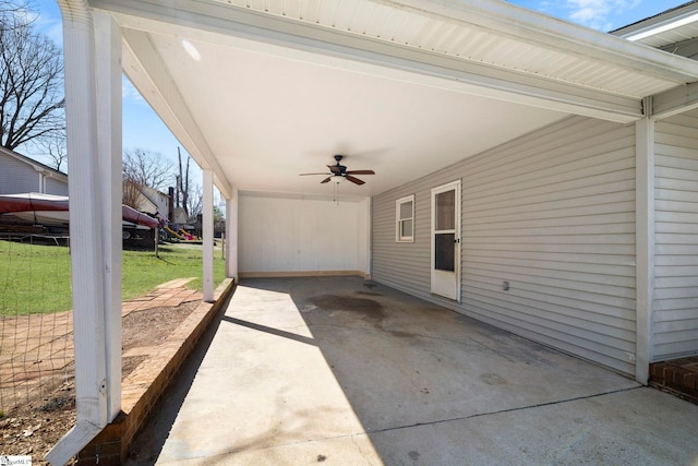 view of patio / terrace with an attached carport, a ceiling fan, and driveway