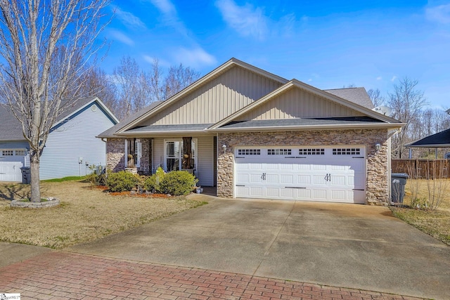 view of front facade with a garage, decorative driveway, and stone siding