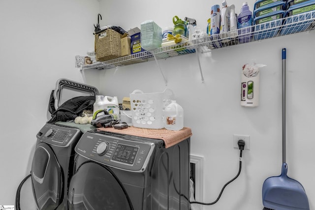 laundry room featuring washing machine and dryer and laundry area