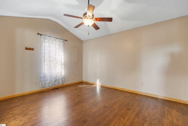 spare room with visible vents, wood finished floors, baseboards, lofted ceiling, and ceiling fan