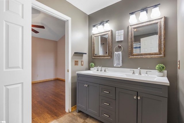 full bath featuring baseboards, wood finished floors, a ceiling fan, and a sink