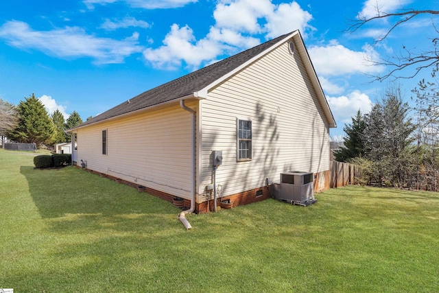 view of side of property with crawl space, a yard, and cooling unit