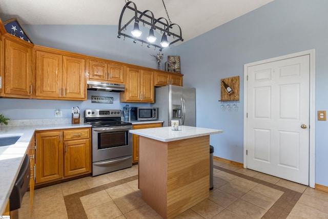 kitchen with light tile patterned floors, stainless steel appliances, vaulted ceiling, light countertops, and under cabinet range hood