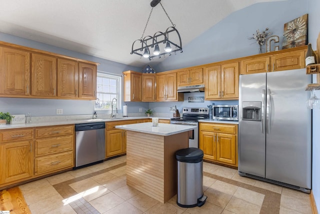 kitchen featuring under cabinet range hood, light countertops, light tile patterned floors, appliances with stainless steel finishes, and a sink