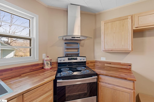 kitchen featuring ornamental molding, light brown cabinets, wood counters, stainless steel electric stove, and wall chimney exhaust hood