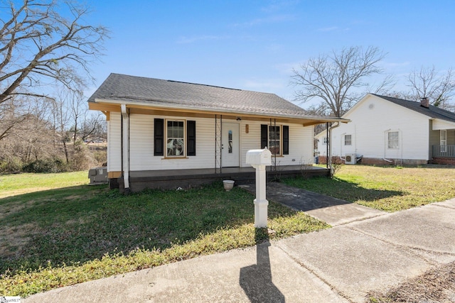 bungalow-style house featuring a porch, a shingled roof, and a front lawn