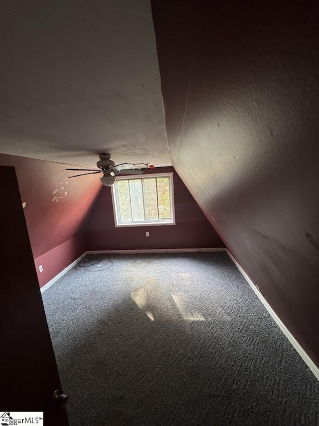 additional living space featuring ceiling fan, lofted ceiling, and carpet