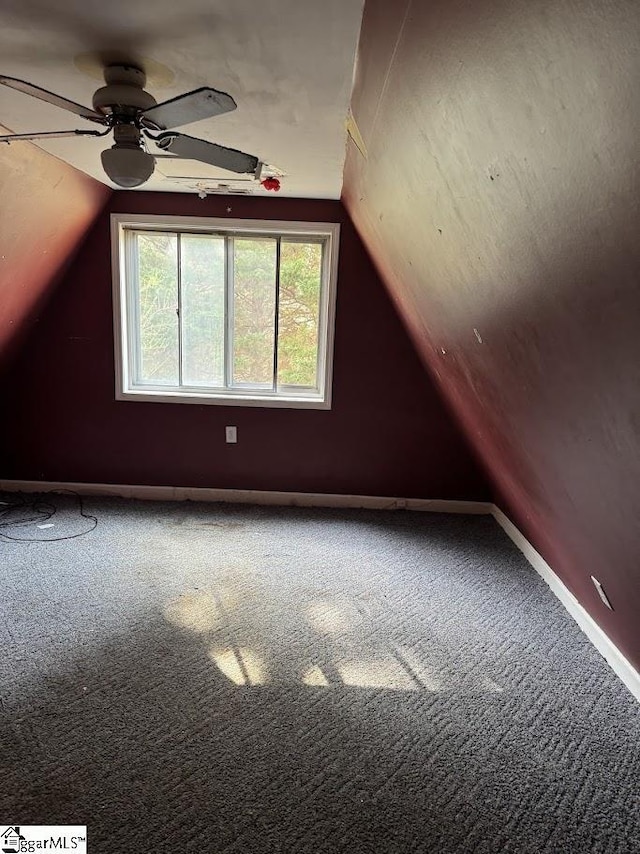 bonus room with vaulted ceiling, a ceiling fan, baseboards, and carpet floors