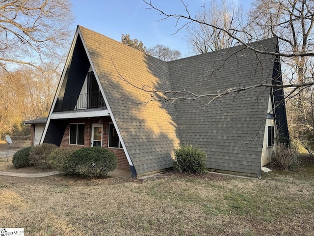 exterior space with a lawn, brick siding, and a shingled roof