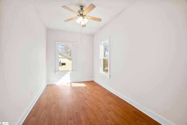 unfurnished room with a ceiling fan, light wood-type flooring, and baseboards