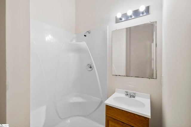 full bathroom featuring vanity and walk in shower