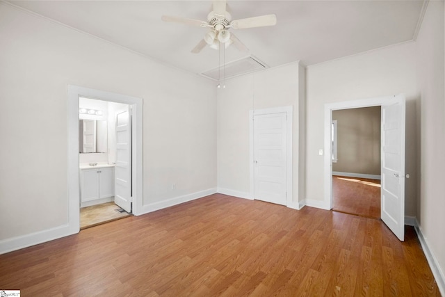 unfurnished bedroom with attic access, baseboards, light wood-type flooring, and a closet