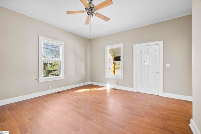 unfurnished room featuring visible vents, baseboards, light wood-type flooring, and ceiling fan