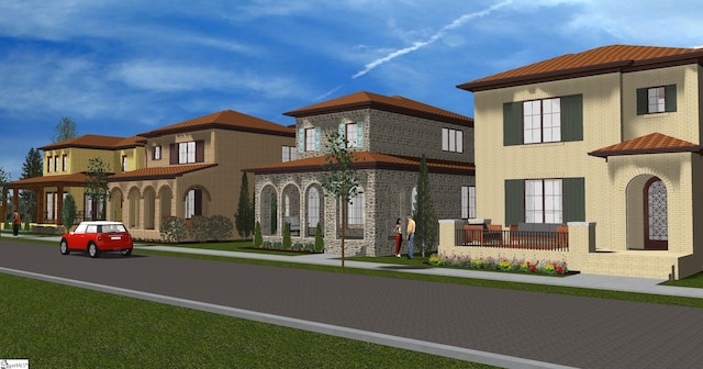 mediterranean / spanish house with brick siding and a porch