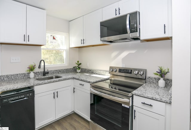 kitchen with white cabinetry, dark wood-style floors, appliances with stainless steel finishes, and a sink