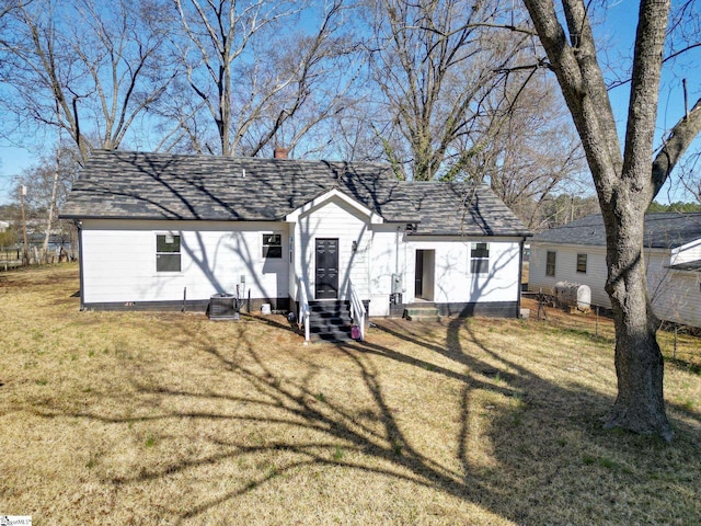 view of front facade featuring a front yard and a chimney