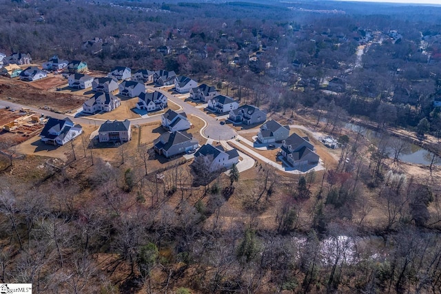 aerial view featuring a wooded view and a residential view