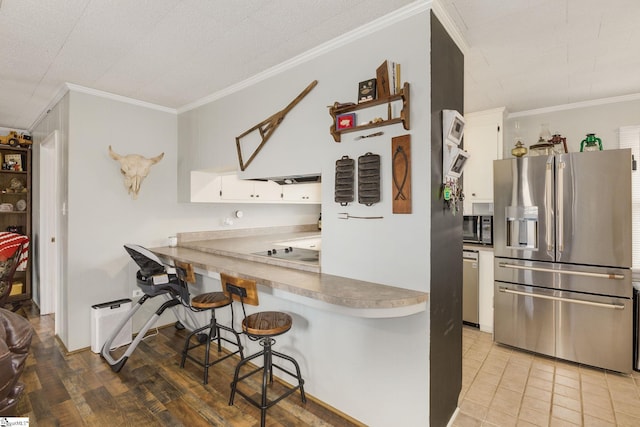 kitchen featuring crown molding, a kitchen breakfast bar, white cabinets, black appliances, and open shelves